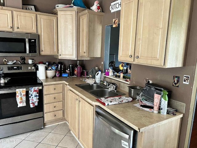 692 NE Hamner Ave, Norton, VA 24273 - kitchen with stainless steel appliances, light brown cabinets, light tile patterned flooring, and light countertops