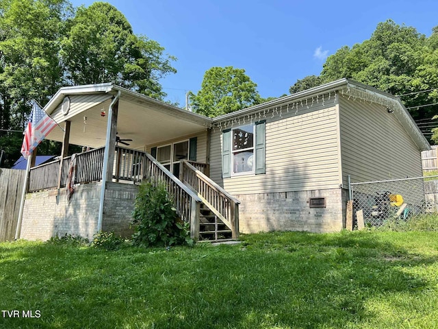 692 NE Hamner Ave, Norton, VA 24273 - rear view of house featuring ceiling fan, crawl space, and stairway