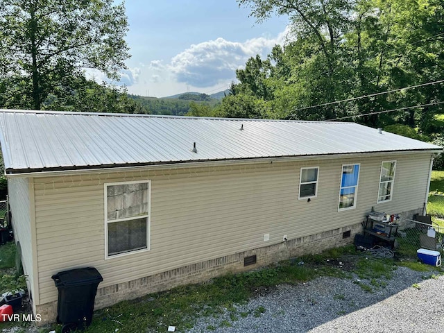 692 NE Hamner Ave, Norton, VA 24273 - view of side of home featuring crawl space and a metal roof