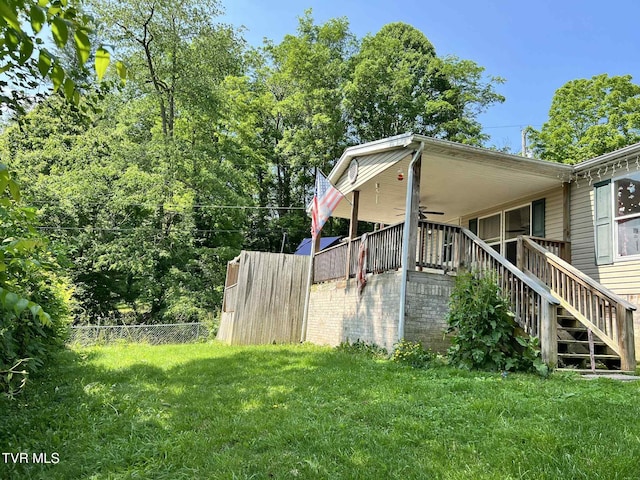 692 NE Hamner Ave, Norton, VA 24273 - view of side of home with ceiling fan and stairway