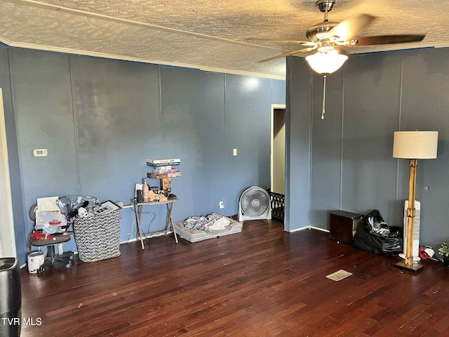 692 NE Hamner Ave, Norton, VA 24273 - miscellaneous room featuring a ceiling fan, wood finished floors, a textured ceiling, and a decorative wall