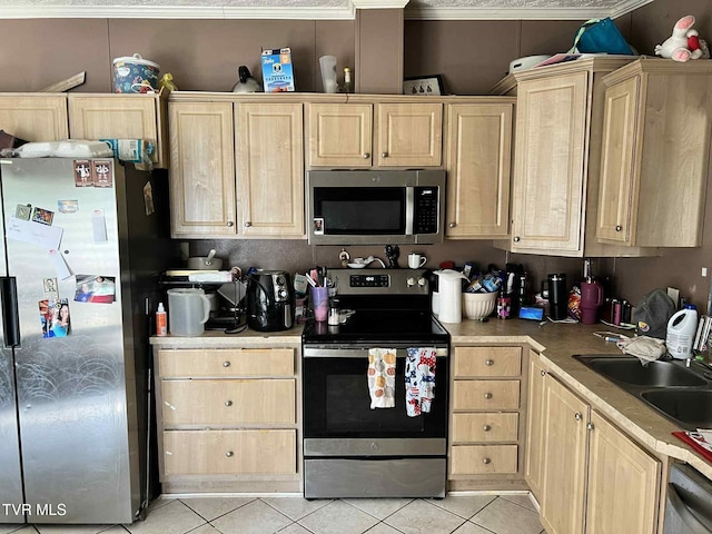 692 NE Hamner Ave, Norton, VA 24273 - kitchen with stainless steel appliances, light brown cabinets, light tile patterned floors, and light countertops