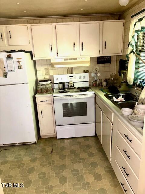 11616 Alfred Cox Rd, Pound, VA 24279 - kitchen featuring white appliances, under cabinet range hood, light countertops, and backsplash