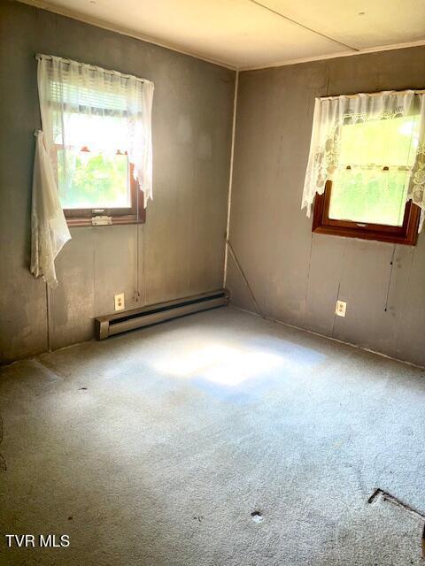 11616 Alfred Cox Rd, Pound, VA 24279 - carpeted empty room featuring a baseboard heating unit