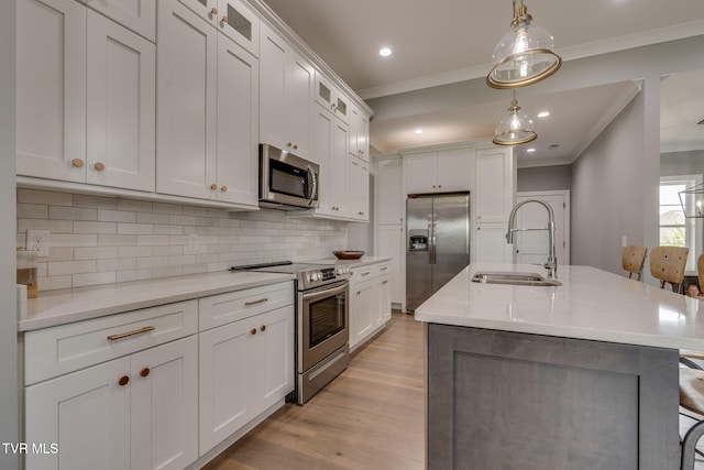 3137 London Rd, Kingsport, TN 37664 - kitchen featuring appliances with stainless steel finishes, ornamental molding, light wood finished floors, decorative backsplash, and white cabinets
