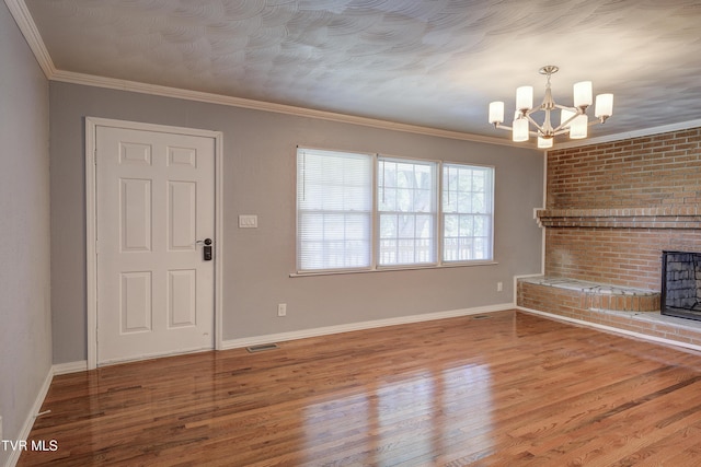 118 Hilbert Cir, Jonesborough, TN 37659 - unfurnished living room featuring a chandelier, a fireplace, wood finished floors, and crown molding