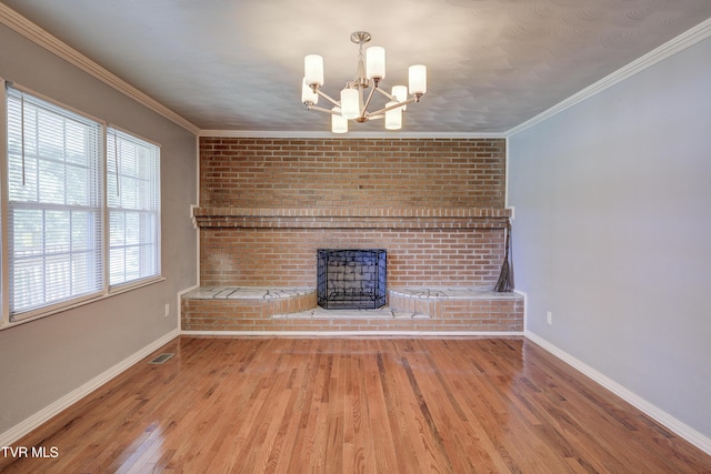 118 Hilbert Cir, Jonesborough, TN 37659 - unfurnished living room featuring a chandelier, a brick fireplace, wood finished floors, and crown molding