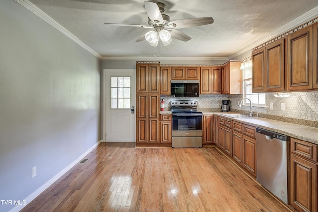 118 Hilbert Cir, Jonesborough, TN 37659 - kitchen with appliances with stainless steel finishes, brown cabinets, ornamental molding, and a textured ceiling