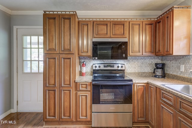 118 Hilbert Cir, Jonesborough, TN 37659 - kitchen with stainless steel range with electric cooktop, brown cabinetry, decorative backsplash, light countertops, and ornamental molding