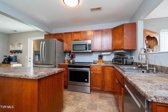 395 Kings Rd, Piney Flats, TN 37686 - kitchen with stainless steel appliances, brown cabinets, and dark countertops