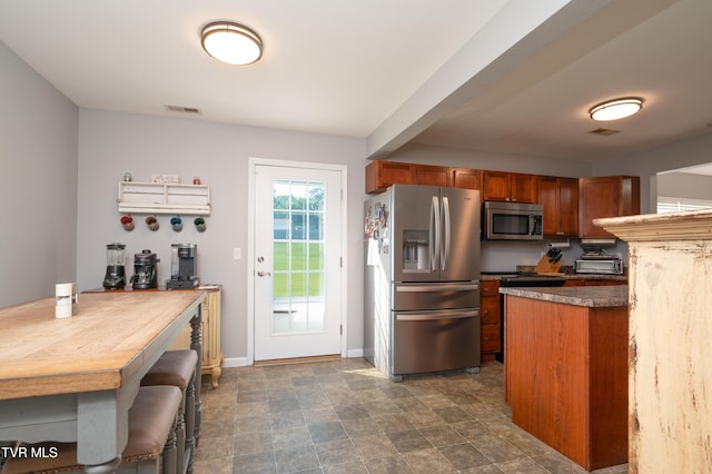 395 Kings Rd, Piney Flats, TN 37686 - kitchen featuring stainless steel appliances, brown cabinetry, and dark countertops
