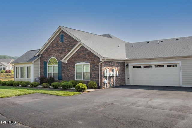 1551 Hatterdale Farm Rd Unit 1551, Blountville, TN 37617 - view of front of property featuring stone siding, driveway, an attached garage, and a shingled roof