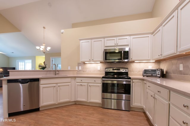1551 Hatterdale Farm Rd Unit 1551, Blountville, TN 37617 - kitchen with stainless steel appliances, a chandelier, a peninsula, lofted ceiling, and light countertops