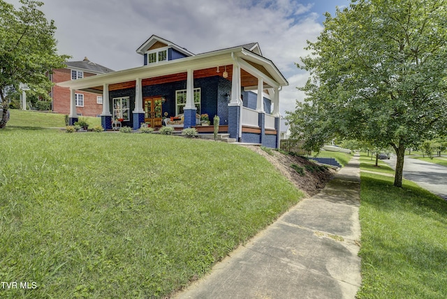 801 Watauga St, Kingsport, TN 37660 - view of front facade with brick siding, a porch, and a front yard