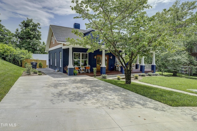 801 Watauga St, Kingsport, TN 37660 - craftsman-style home featuring a porch, brick siding, a chimney, and driveway