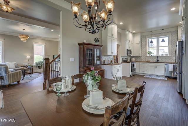 801 Watauga St, Kingsport, TN 37660 - dining room with stairway, crown molding, dark wood finished floors, a chandelier, and recessed lighting