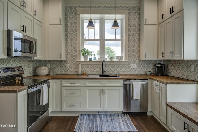 801 Watauga St, Kingsport, TN 37660 - kitchen featuring butcher block countertops, appliances with stainless steel finishes, dark wood finished floors, and backsplash