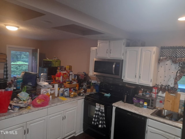 1080 Nicole Pl, Kingsport, TN 37660 - kitchen with black appliances, white cabinets, and light countertops