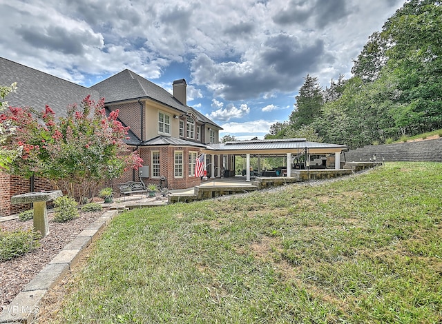 287 Pactolus Rd, Kingsport, TN 37663 - rear view of house featuring a chimney, a yard, brick siding, and a patio area