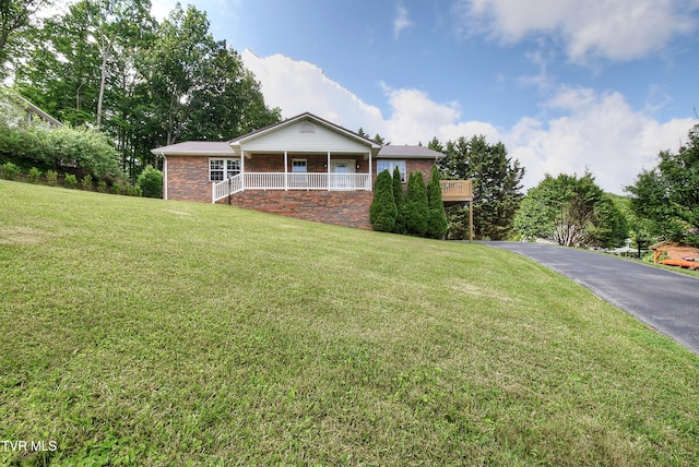 102 Spring Hill Dr, Unicoi, TN 37692 - ranch-style home with a front lawn, a porch, and brick siding
