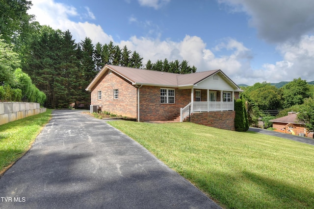 102 Spring Hill Dr, Unicoi, TN 37692 - ranch-style house with covered porch, asphalt driveway, a front yard, and a metal roof