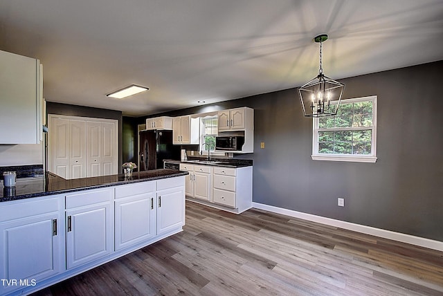 102 Spring Hill Dr, Unicoi, TN 37692 - kitchen featuring black appliances, dark wood finished floors, a peninsula, and white cabinetry