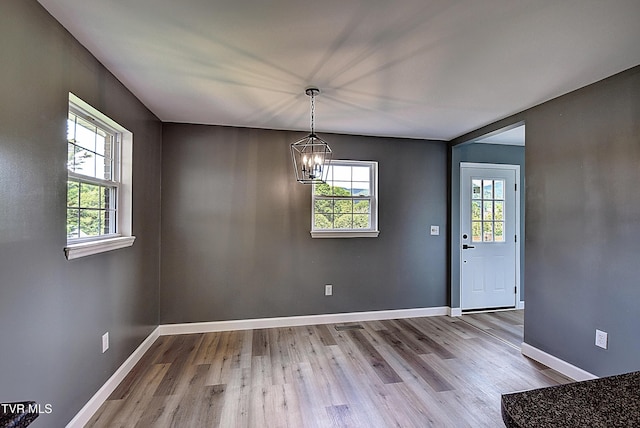 102 Spring Hill Dr, Unicoi, TN 37692 - unfurnished dining area with a chandelier, healthy amount of natural light, and wood finished floors