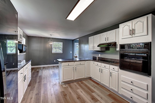 102 Spring Hill Dr, Unicoi, TN 37692 - kitchen featuring black appliances, a peninsula, light wood-style floors, white cabinets, and under cabinet range hood