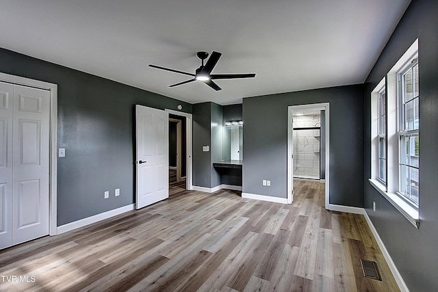 102 Spring Hill Dr, Unicoi, TN 37692 - unfurnished bedroom with wood finished floors, a ceiling fan, and ensuite bathroom