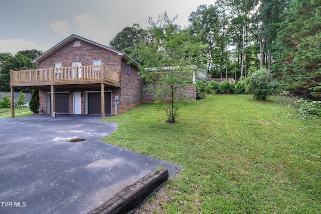 102 Spring Hill Dr, Unicoi, TN 37692 - view of front of house featuring driveway, brick siding, an attached garage, a front yard, and a deck