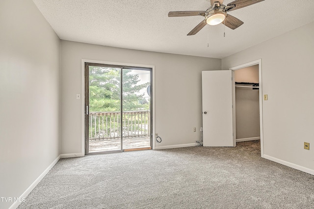 103 Northwinds Dr, Bristol, VA 24201 - unfurnished bedroom with access to exterior, carpet flooring, a textured ceiling, a spacious closet, and a ceiling fan