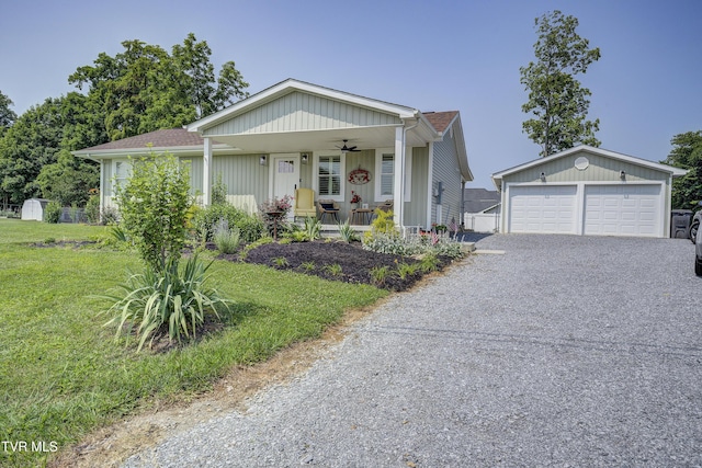 457 W St, Greeneville, TN 37745 - view of front of property featuring an outbuilding, a porch, ceiling fan, a front lawn, and a garage