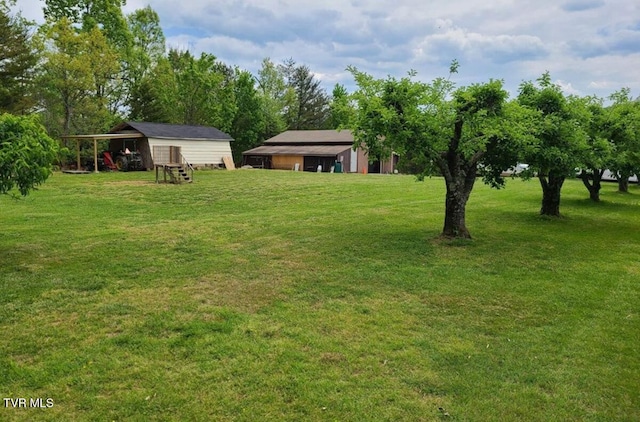 3521 James Phillips Way, Sevierville, TN 37876 - view of grassy yard with a pole building, an outdoor structure, and a carport