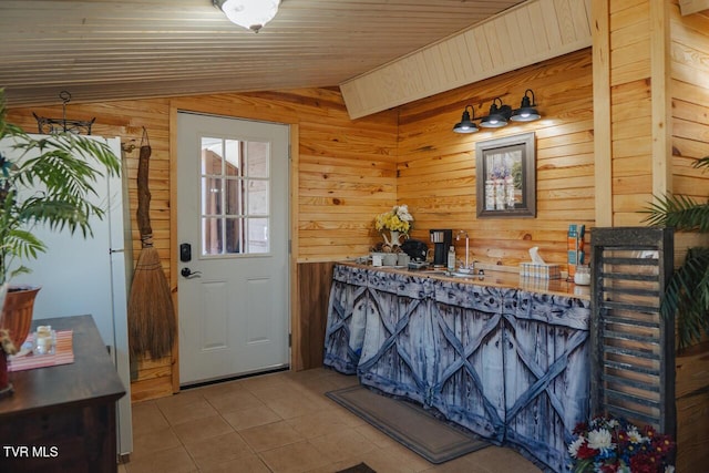 3521 James Phillips Way, Sevierville, TN 37876 - bar area with lofted ceiling, tile patterned flooring, and wooden walls