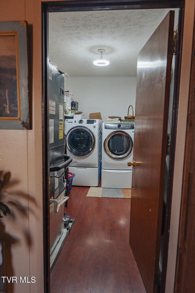 3521 James Phillips Way, Sevierville, TN 37876 - laundry room featuring washer and dryer, wood finished floors, and a textured ceiling