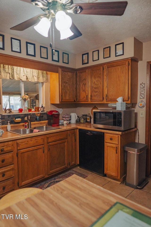 3521 James Phillips Way, Sevierville, TN 37876 - kitchen featuring dishwasher, stainless steel microwave, brown cabinets, a ceiling fan, and light tile patterned floors