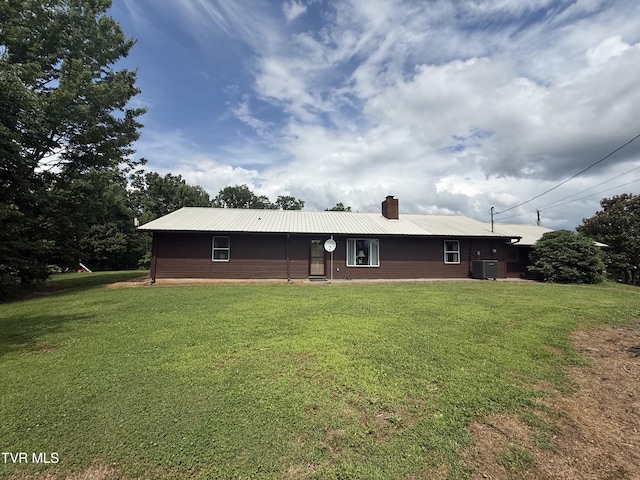3521 James Phillips Way, Sevierville, TN 37876 - view of front of home featuring a chimney, a front yard, and a metal roof