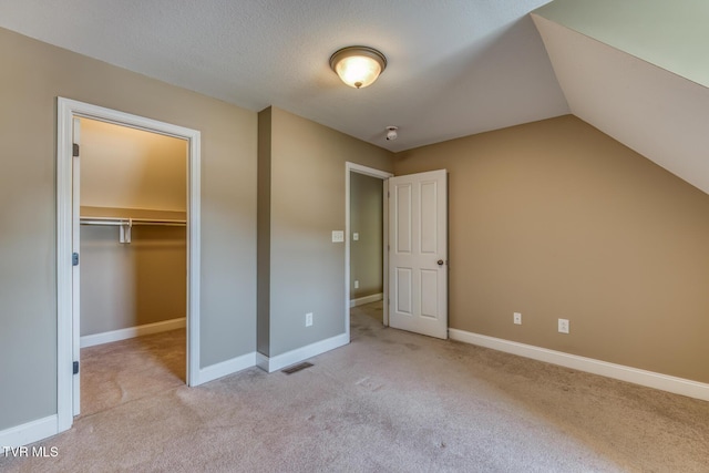 82 Hiddenbrook Ln Unit 82, Gray, TN 37615 - unfurnished bedroom featuring carpet, a walk in closet, a closet, and lofted ceiling