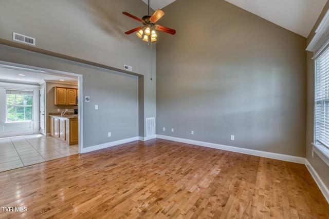 82 Hiddenbrook Ln Unit 82, Gray, TN 37615 - spare room featuring light wood-style flooring, ceiling fan, and high vaulted ceiling
