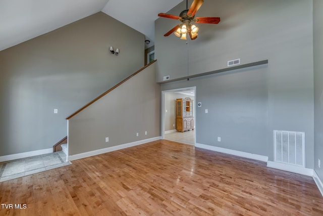 82 Hiddenbrook Ln Unit 82, Gray, TN 37615 - unfurnished living room with high vaulted ceiling, a ceiling fan, stairs, and wood finished floors