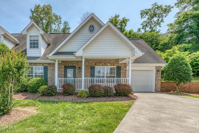 82 Hiddenbrook Ln Unit 82, Gray, TN 37615 - view of front of property featuring a porch, brick siding, a garage, driveway, and roof with shingles