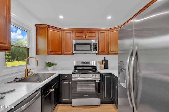 252 Kiser Cir, Jonesborough, TN 37659 - kitchen with stainless steel appliances, light countertops, recessed lighting, light wood-style floors, and brown cabinets