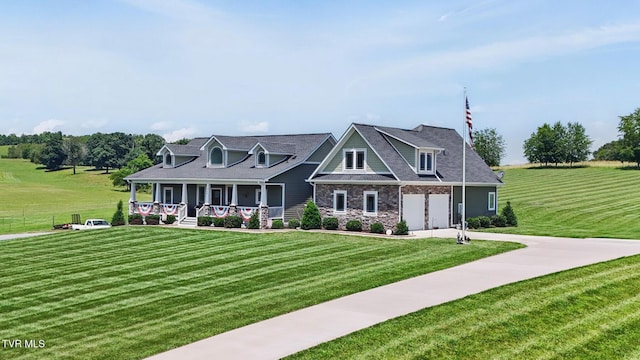 313 Treadway Trl, Jonesborough, TN 37659 - view of front of home featuring covered porch, concrete driveway, a front yard, and stone siding