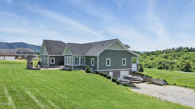 313 Treadway Trl, Jonesborough, TN 37659 - rear view of house with a garage, a sunroom, a lawn, and a mountain view