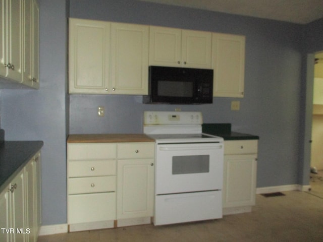1234 Bristol Hwy, Elizabethton, TN 37643 - kitchen featuring black microwave, electric stove, white cabinets, and dark countertops