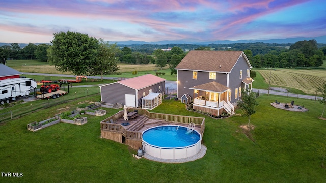695 Opie Arnold Rd, Limestone, TN 37681 - back of house featuring a fire pit, an outdoor pool, a wooden deck, a rural view, and a vegetable garden