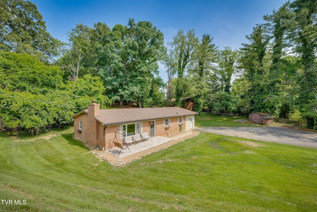 309 Knob Hill Dr, Bristol, TN 37620 - view of front facade featuring a chimney, a storage unit, a front lawn, and a garage