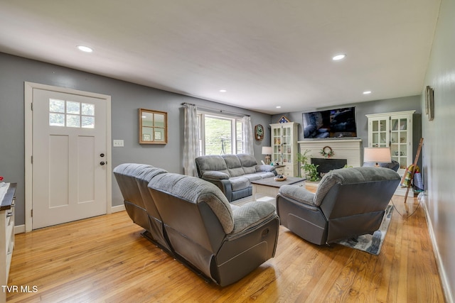 309 Knob Hill Dr, Bristol, TN 37620 - living room featuring light wood-style flooring, a brick fireplace, and recessed lighting