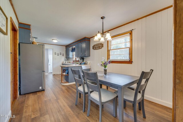 309 Knob Hill Dr, Bristol, TN 37620 - dining area with a chandelier, wood finished floors, and crown molding