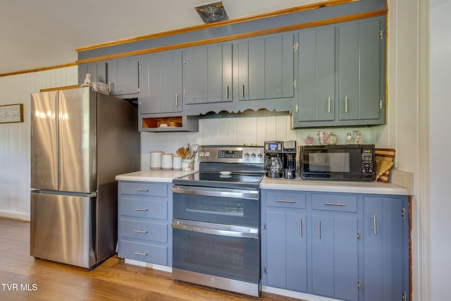 309 Knob Hill Dr, Bristol, TN 37620 - kitchen with appliances with stainless steel finishes, light countertops, light wood-style floors, and blue cabinets